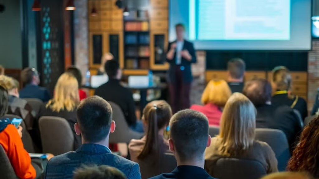 A business analyst presenting data insights to colleagues in a conference room, fostering teamwork and strategic planning.