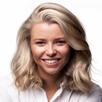 Headshot of Laura Clemesha, smiling, with blonde hair and wearing a white shirt.