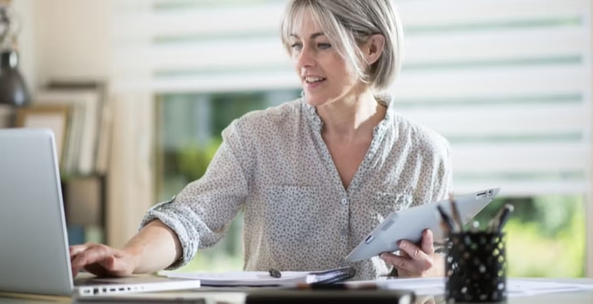 A business woman working on her laptop in a home office.