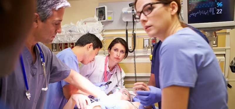 A medical team working together in an emergency room, focused on providing critical care to a patient.