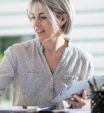 A business woman working on her laptop in a home office.