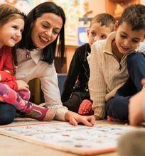 A teacher engaging with children during an interactive learning session in a classroom.