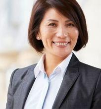 A smiling businesswoman in a professional setting, symbolizing career growth.