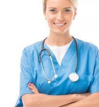 A smiling healthcare worker in scrubs, symbolizing compassion and dedication in the medical profession.
